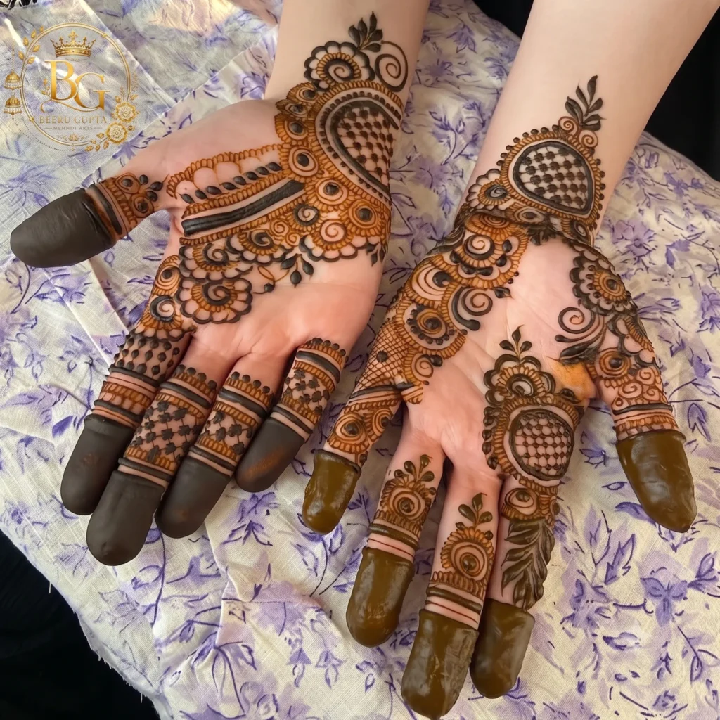 Beautiful Arabic mehndi design for both hands with floral motifs, paisley patterns, mesh filling, and bold finger detailing.